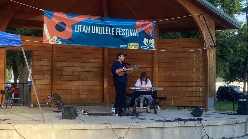 Ukulele player Kris Fuchigami performing at the 2026 Utah Ukulele Festival in Logan, Utah.