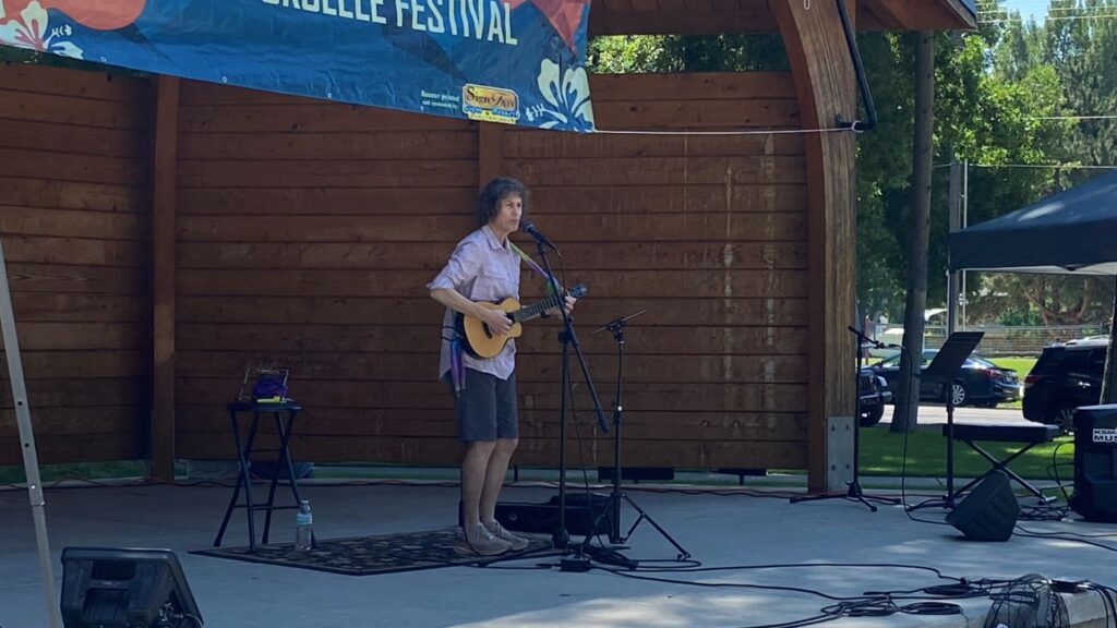 Ukulele player Sue Schnitzer performing at the 2026 Utah Ukulele Festival in Logan, Utah.