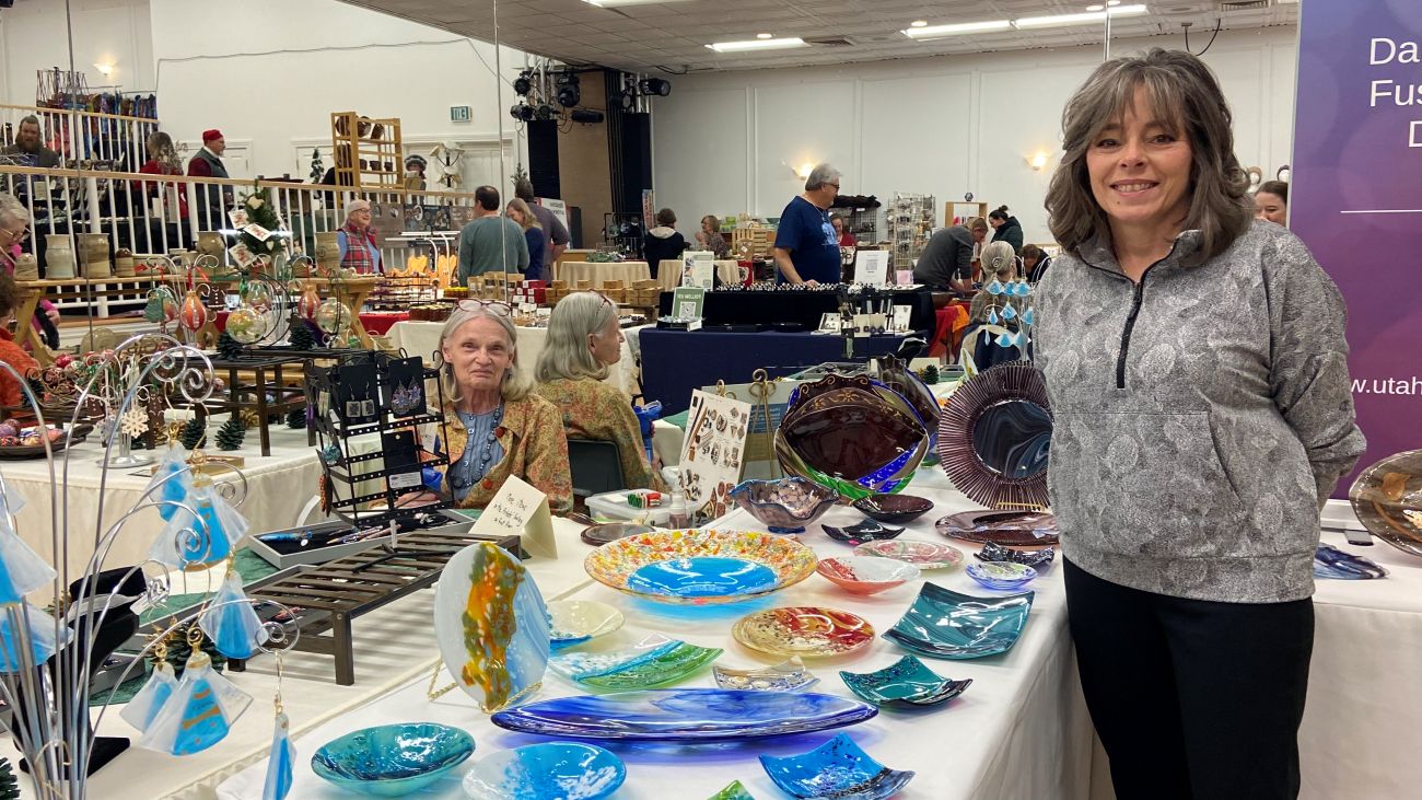 Vendors displaying their handmade glassware at the Winter Gift Market in Logan, Utah.